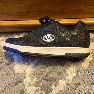 Black women’s size 7 Heelys barely worn,wheels still spin very well.